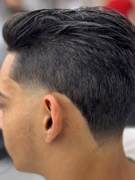 Textured Pompadour Sweep & Low Taper Fade - Flowing swept-back pompadour top paired with a tight low scissor taper and natural neckline taper.